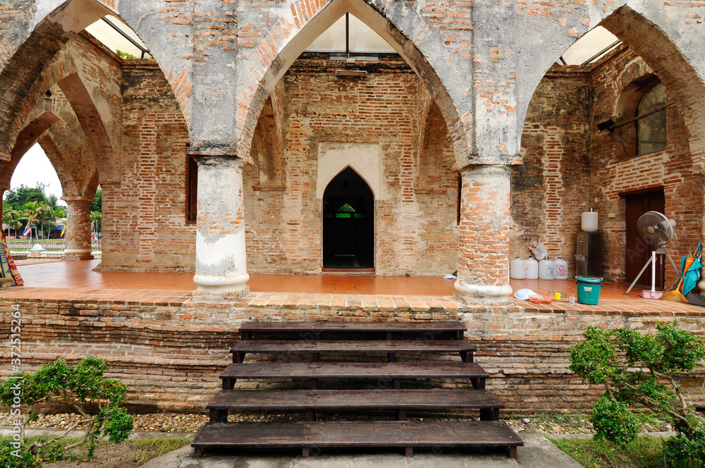 PATTANI, THAILAND -JULY 10, 2014: Historic Kru Se mosque which is made of bricks with round pillars. The mosque represents a unique Islamic civilization of the Kingdom of Pattani in Thailand. PATTANI, THAILAND -JULY 10, 2014: Historic Kru Se mosque which is made of bricks with round pillars. The mosque represents a unique Islamic civilization of the Kingdom of Pattani in Thailand.