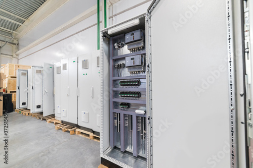 Industrial production of an electricity panel boards - several boards standing one by one photo