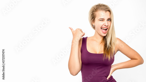 Young female with blond hair posing against white background. Emotions.