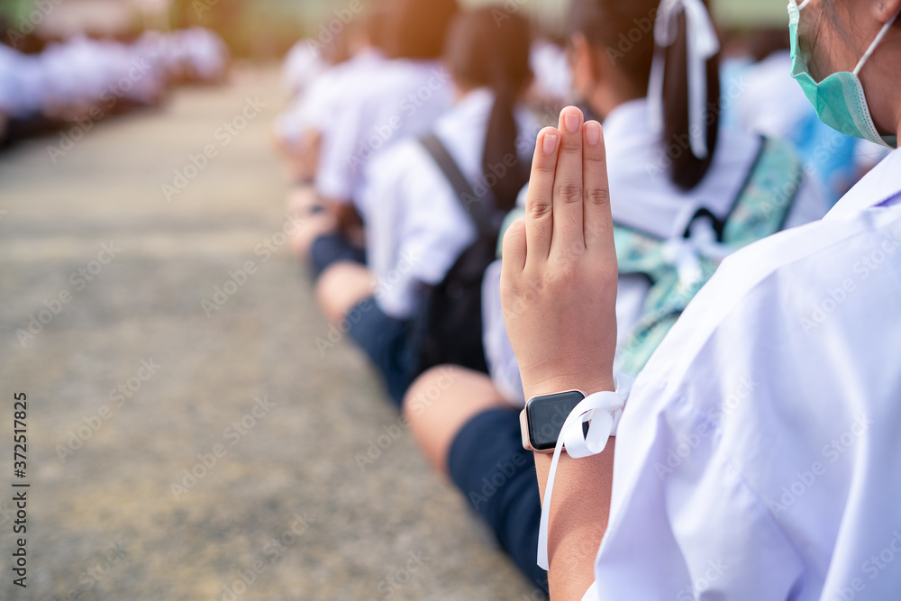 Students girl showing three finger salute in school