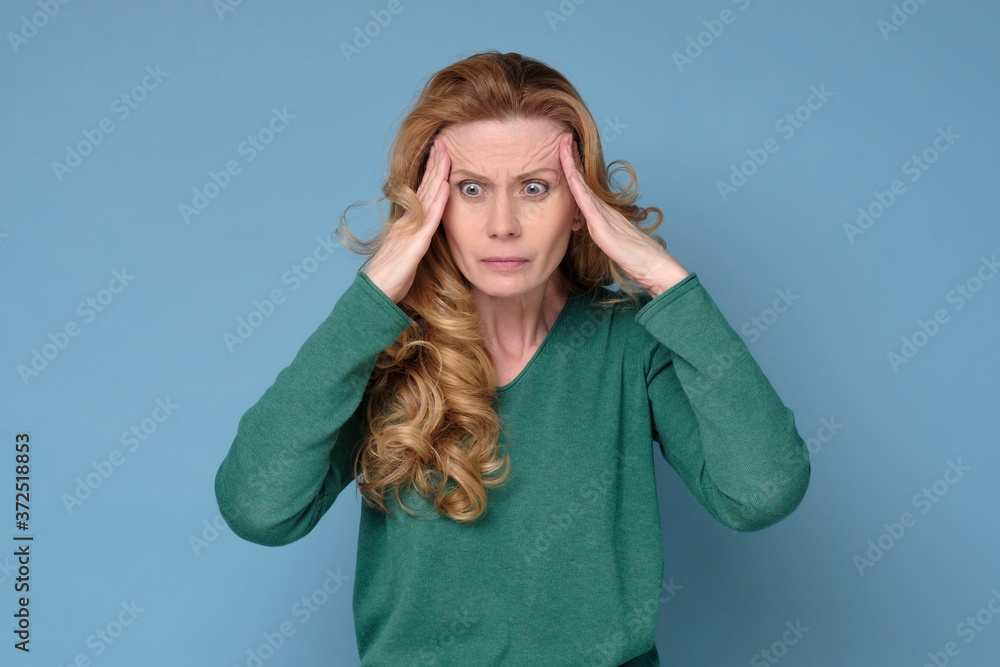 © Viktor Koldunov - Mature senior woman has a headache holding hands on head. Studio shot © Viktor Koldunov - Mature senior woman has a headache holding hands on head. Studio shot