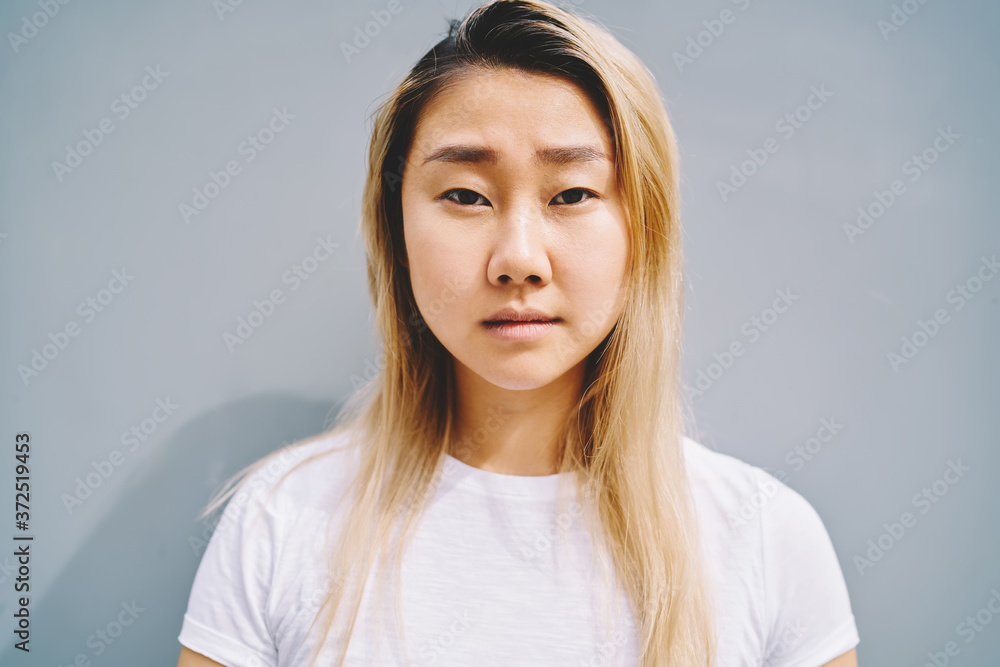 Portrait of attractive serious and sad asian female person posing