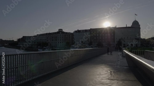 Sunset over Copenhagen as seen from the Inderhavnsbroen bridge. Shot with lens flare. photo