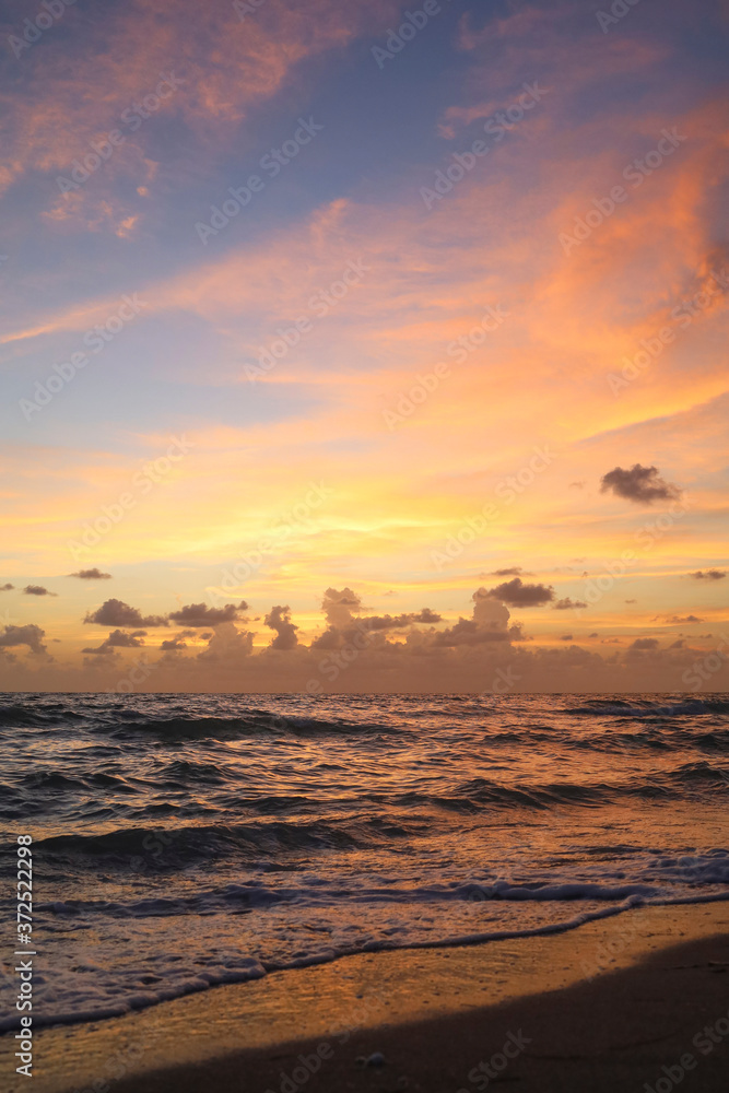 Sunset in Captiva Sanibel Island, Florida. Gulf of Mexico at dusk. Sun sets over beach on Captiva Island over calm waters. Illuminated dreamy summer sunset.