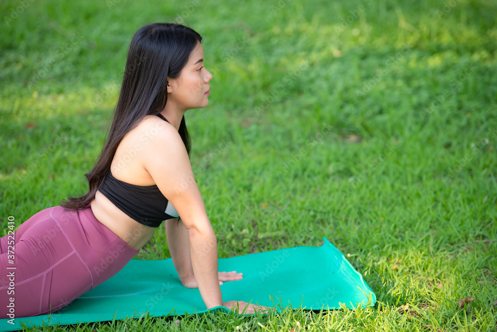 Beautiful asian fat woman play yoga at the park,Need to slim fit