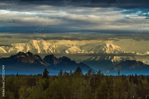 Early morning shot of the Alaska range.  The Alaska Range is a relatively narrow mountain range in the southcentral region of the U.S. state of Alaska. photo