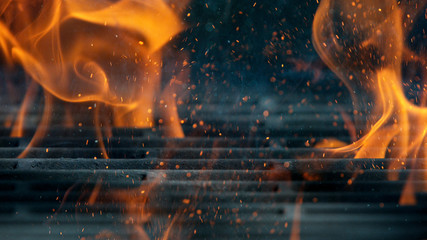 Empty flaming cast iron grate charcoal grill with open fire, ready for product placement.