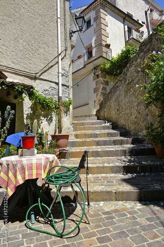 A narrow street among the old houses of Altomonte, a rural village in the Calabria region. photo