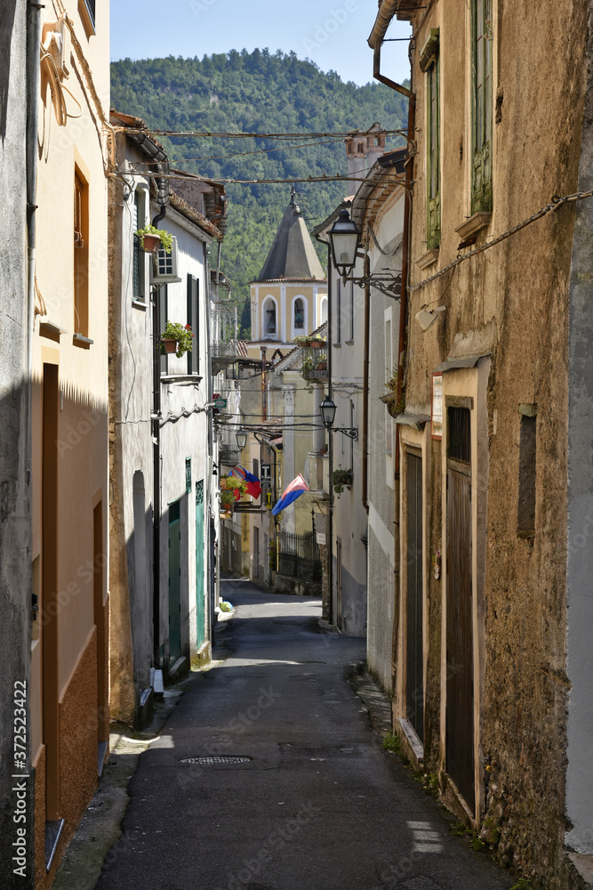 A narrow street among the old houses of Laino Borgo, a rural village in the Calabria region.
