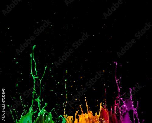 Abstract sculptures of colorful splashes of paint. Dancing liquid on a black background.