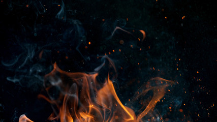 fire flames with sparks on a black background, close-up