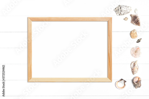 Horizontal wooden frame and seashells on a white background
