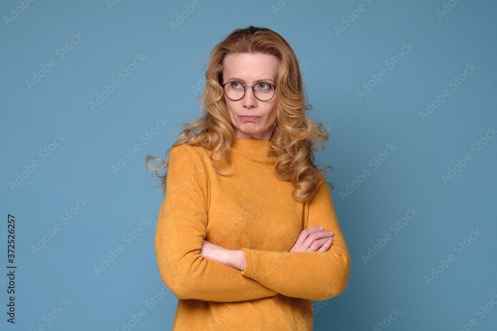 © Viktor Koldunov - Offended unhappy mature woman with long blonde hair keeps hands crossed, curves lips, displeased with everything © Viktor Koldunov - Offended unhappy mature woman with long blonde hair keeps hands crossed, curves lips, displeased with everything