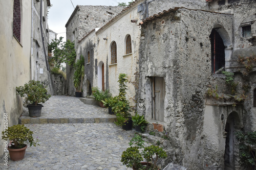 Fototapeta Naklejka Na Ścianę i Meble -  A narrow street among the old houses of Scalea, a rural village in the Calabria region, Italy.