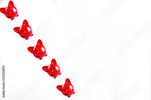 concept of saving money in a red piggy Bank. pattern of red piggy banks on a light background. photo