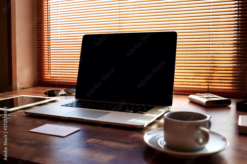 Fototapeta premium Mock up of modern freelancer workplace with luxury accessories and work tools,cup of american coffee, envelope, tablet and laptop computer with blank copy space for text message or advertising content