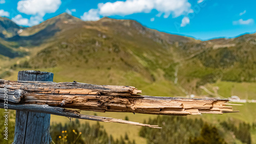 Beautiful alpine view with details of a broken fence at the famous Zillertaler Hoehenstrasse, Tyrol, Austria photo