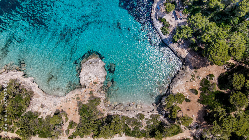 Beautiful aerial view of Mediterranean white sand beach and turquoise water in Menorca Spain, Cala Mitjana, aerial top view drone photo