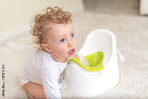 Child girl on the potty.