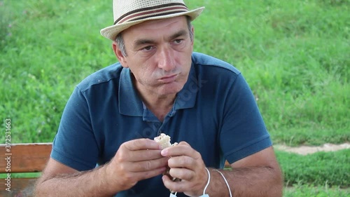 Middle Age Man Eating Fast Food Then Wearing Medical Mask After  Finishing Meal
