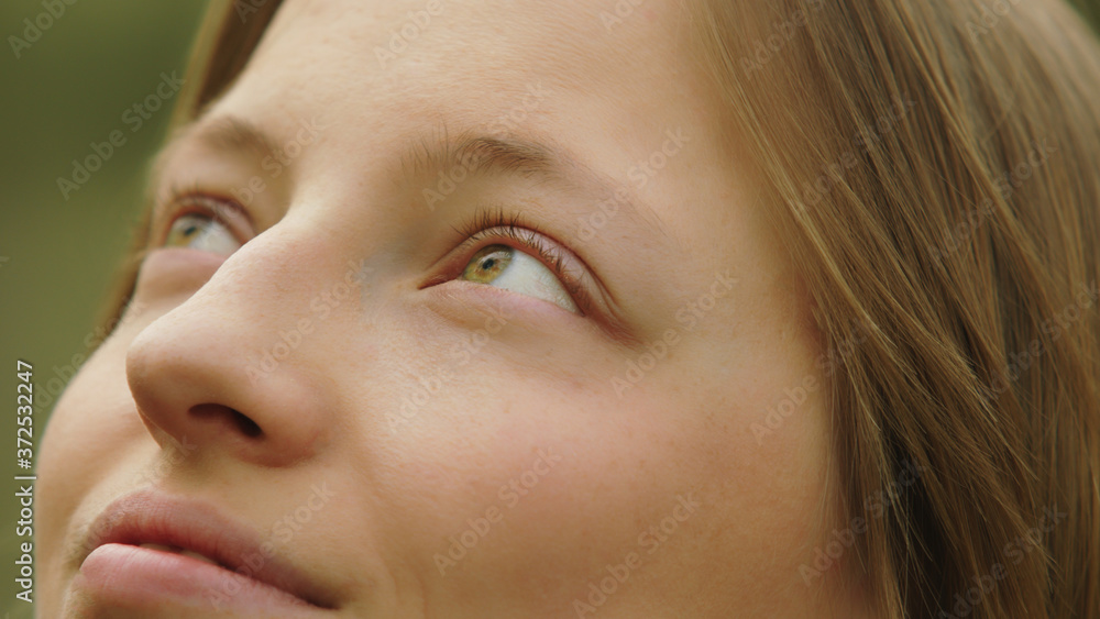 Close up shot of smiling caucasian woman with green azzure eyes looking up. High quality photo Close up shot of smiling caucasian woman with green azzure eyes looking up. High quality photo