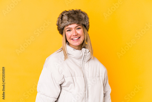 Young caucasian woman wearing a winter clothes isolated happy, smiling and cheerful.