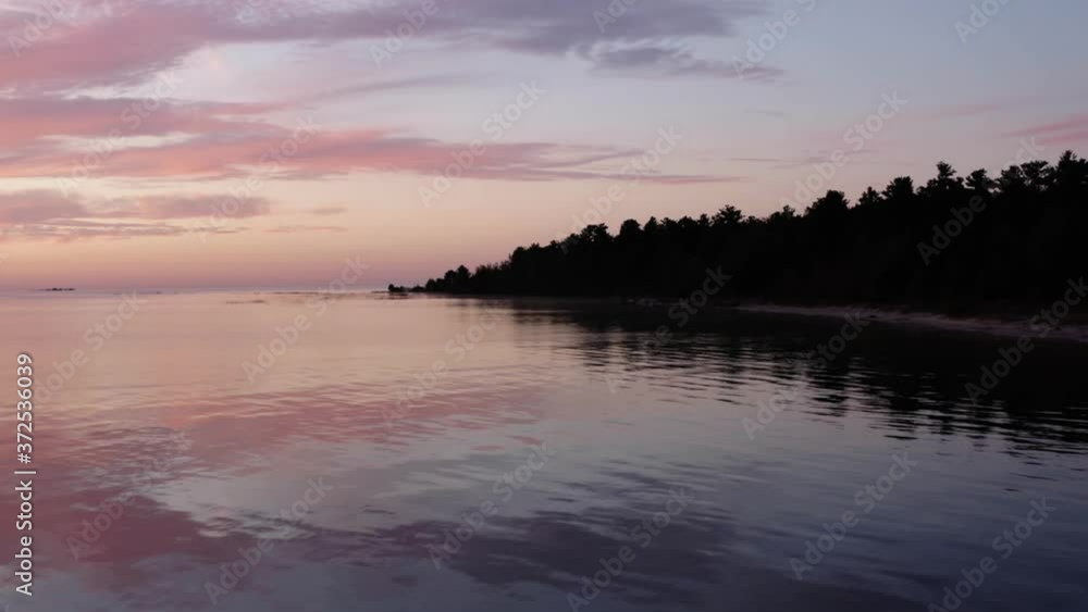 Flying Away From Island Over Beautiful Lake during spectacular Sunset, departing Flying Away From Island Over Beautiful Lake during spectacular Sunset, departing