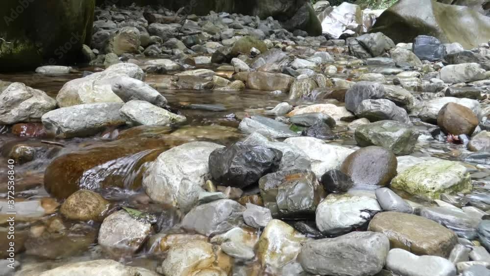 Small Creek In The Mountains. Fast water stream flow between old rocks.Natural background. Small Creek In The Mountains. Fast water stream flow between old rocks.Natural background.