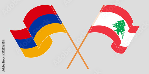 Crossed and waving flags of Lebanon and Armenia