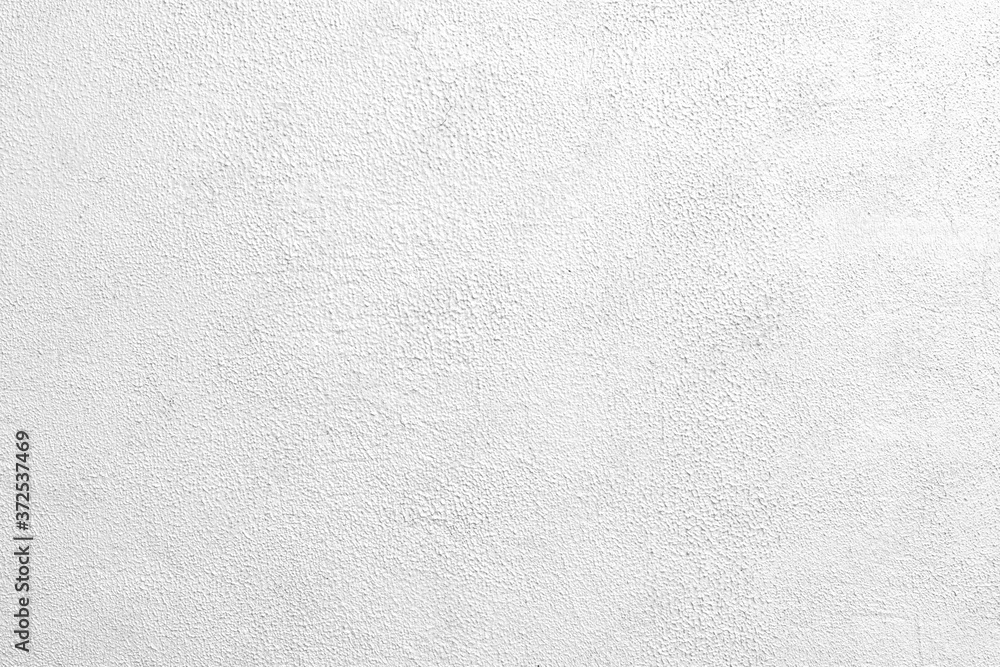 White wall of the building. Rough plaster surface. Abstract background. White wall of the building. Rough plaster surface. Abstract background.
