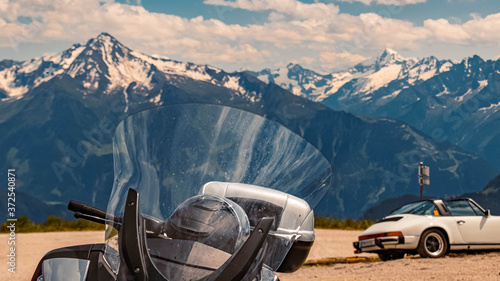 Beautiful alpine view with details of a motorbike windshield and a sportscar in the background at the famous Zillertaler Hoehenstrasse, Tyrol, Austria © Martin Erdniss