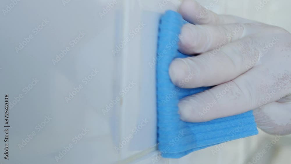 Closeup Image with Hands Wearing White Protective Household Gloves Who Cleans and Disinfects Kitchen Faience Closeup Image with Hands Wearing White Protective Household Gloves Who Cleans and Disinfects Kitchen Faience