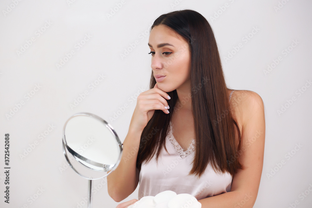 Beautiful woman face close up studio on white, brunette in nightgown Beautiful woman face close up studio on white, brunette in nightgown