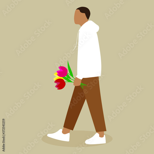 A man carries a bouquet of flowers