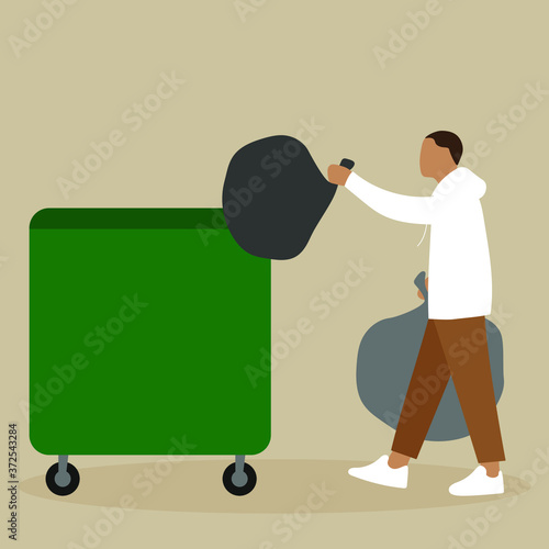 A man throws a garbage bag into a trash can