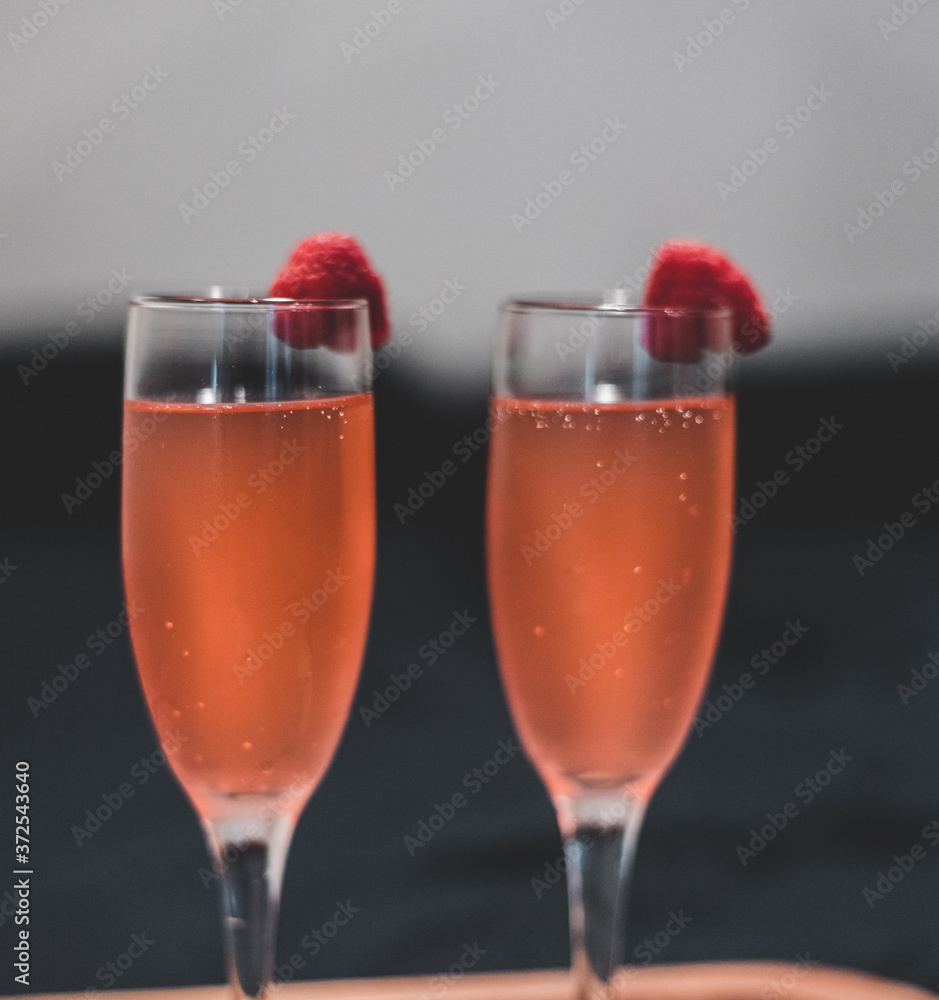 Sparkling drink in wine glass with raspberry Sparkling drink in wine glass with raspberry