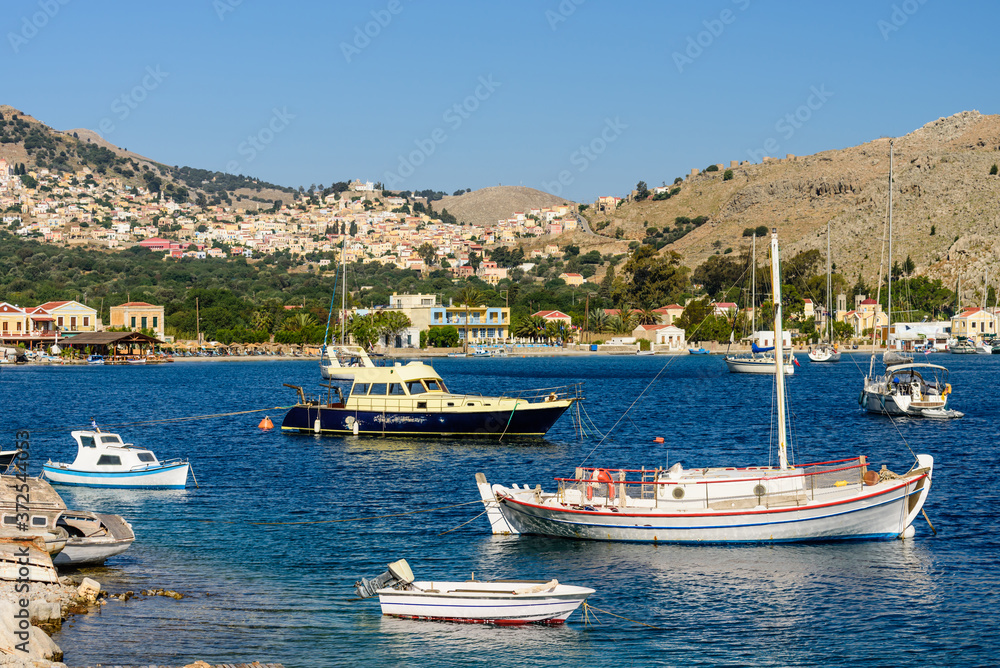 Picturesque Bay with fishing boats in the village of Pedi, Symi island, Dodecanese Islands, Greece