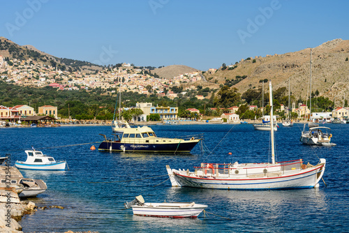 Picturesque Bay with fishing boats in the village of Pedi, Symi island, Dodecanese Islands, Greece