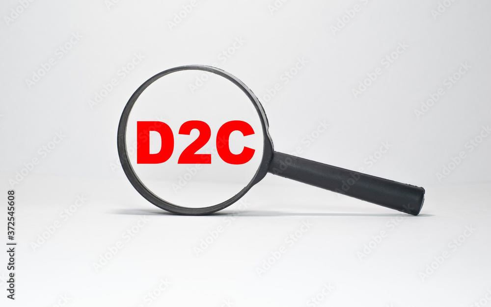 D2C inscription in a magnifying glass on a boundless white background D2C inscription in a magnifying glass on a boundless white background