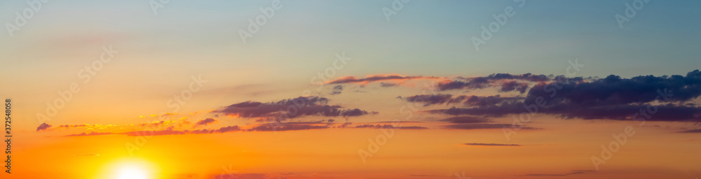 Panorama of picturesque sky with clouds during sunset