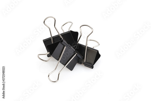 Stationery metal binder clips isolated on white background. Paper clips tool for paper documents clamping. Office metal foldback braces. Close-up.