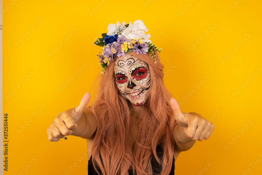 Young blonde woman over isolated background approving doing positive gesture with hand, thumbs up smiling and happy for success. Looking at the camera, winner gesture. Young blonde woman over isolated background approving doing positive gesture with hand, thumbs up smiling and happy for success. Looking at the camera, winner gesture.