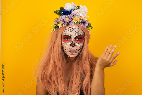 What the hell are you talking about, nonsense. Studio shot of frustrated female wearing halloween make up gesturing with raised palm, frowning, being displeased and confused with dumb question-