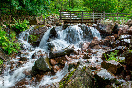 A waterfall on the footpath around Buttermere lake  in the English Lake District, Cumbria, England. Popular with visitors due to its scenery, Buttermere means 'the lake by the dairy pastures' photo