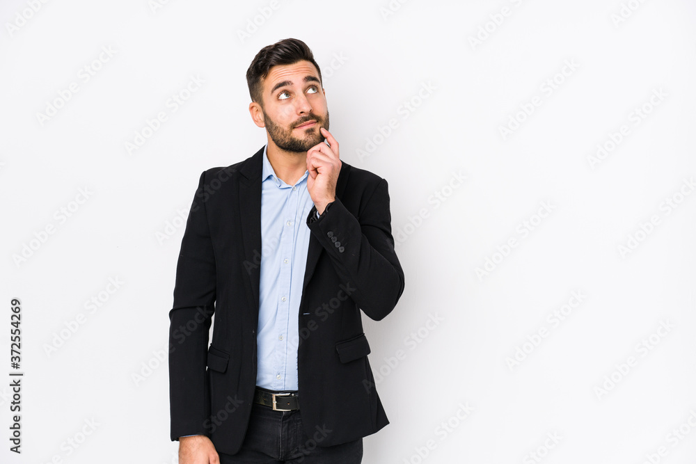 Young caucasian business man against a white background isolated looking sideways with doubtful and skeptical expression. Young caucasian business man against a white background isolated looking sideways with doubtful and skeptical expression.
