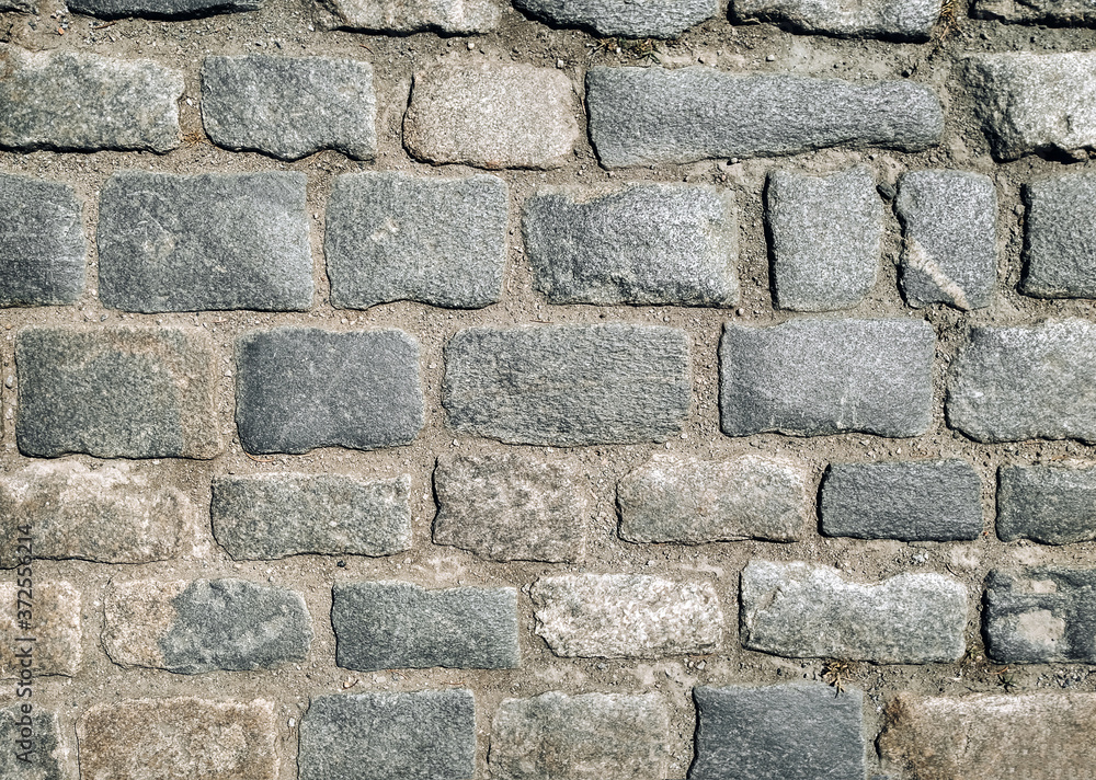 Texture of gray granite paving stones, top view. Background from natural block stone. Texture of gray granite paving stones, top view. Background from natural block stone.
