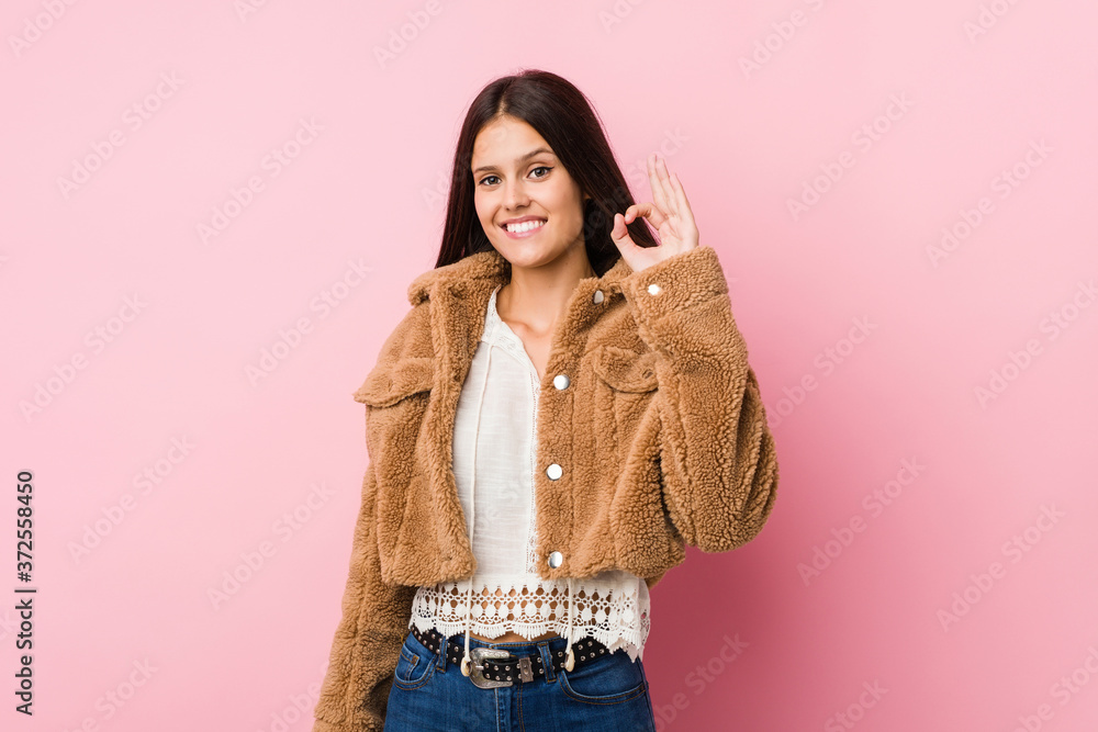 Young cute woman cheerful and confident showing ok gesture. Young cute woman cheerful and confident showing ok gesture.