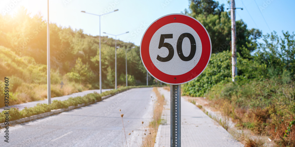 speed limit road sign in red circle on asphalt highway speed limit road sign in red circle on asphalt highway