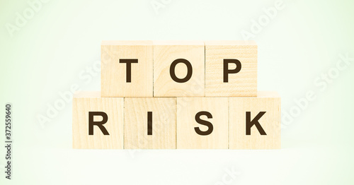 words top risk with black letters on small wooden blocks