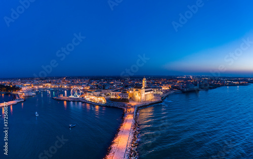 Wallpaper Mural Italy, Puglia, Trani, Pier on sea and Cathedral of San Nicola Pellegrino at night, aerial view Torontodigital.ca